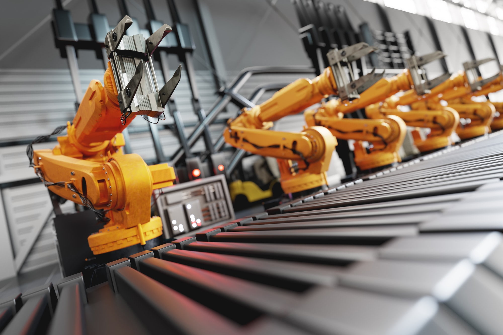 Robotic arms along assembly line in modern factory.